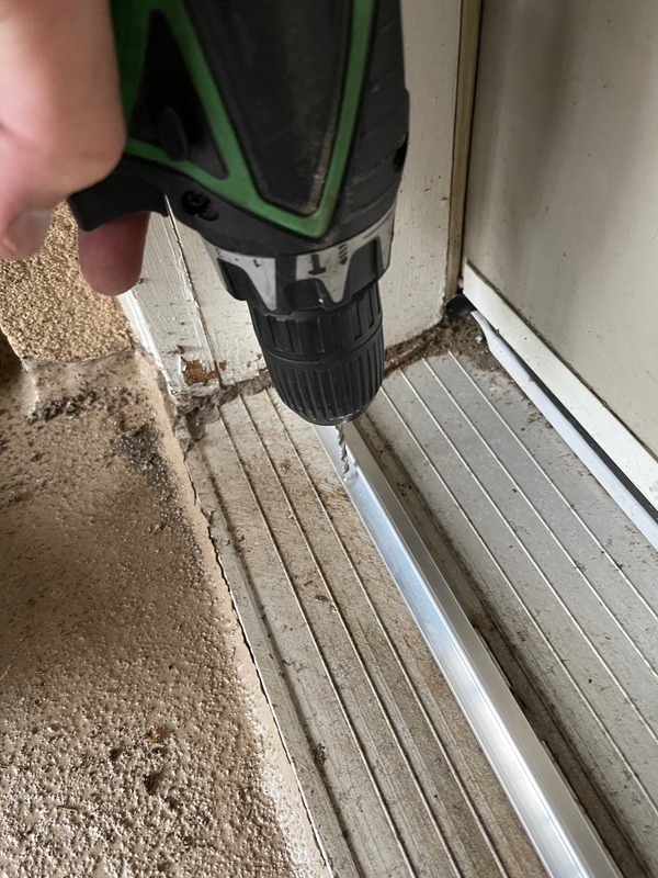 Drilling a french door screen door track in preparation for rivets