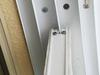 Glass patio door guided by top fin