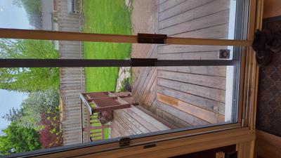 Patio door with screen door between glass panels